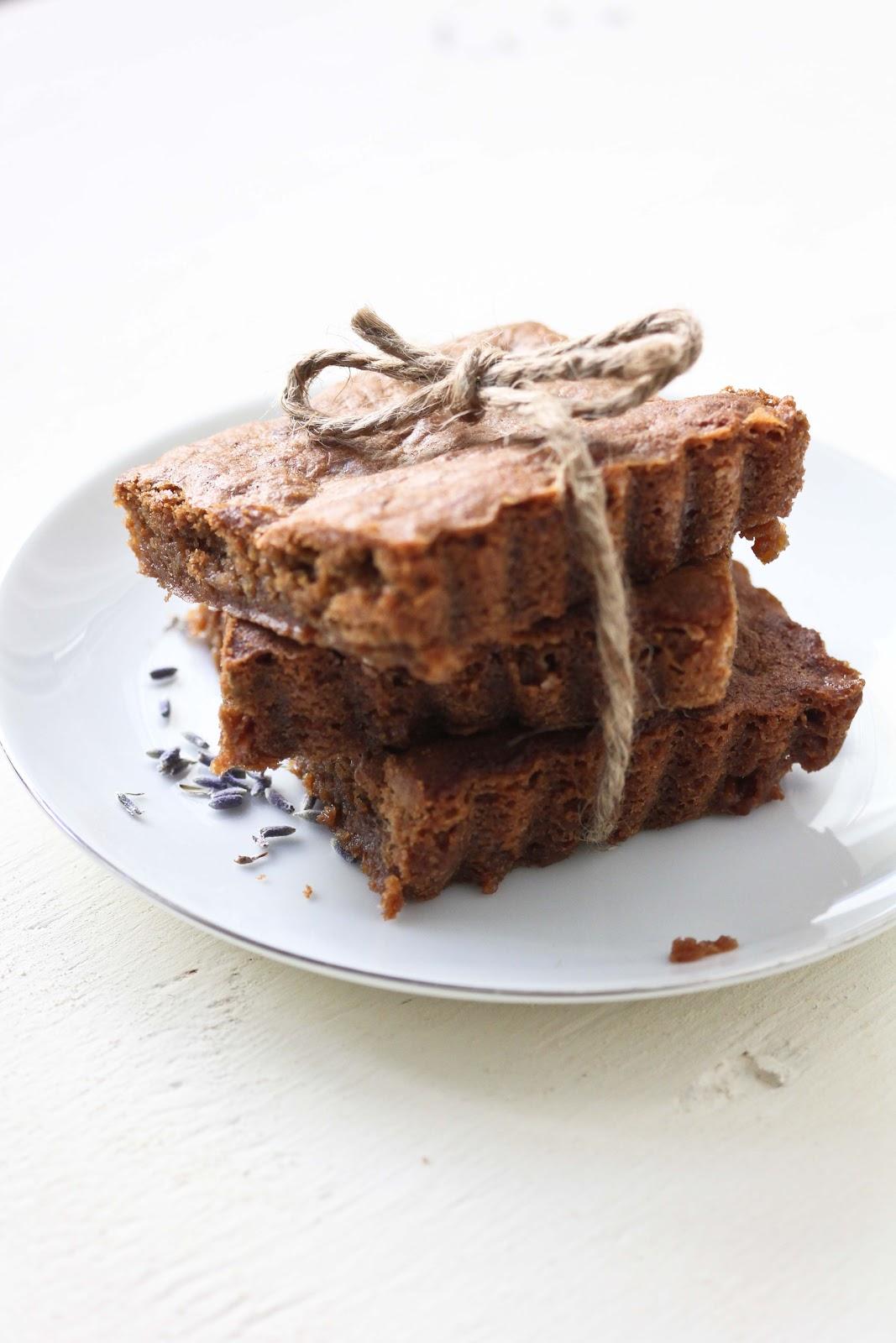 a person taking a bite of a lavender vanilla brownie
