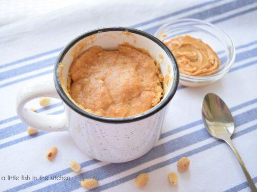 Person enjoying a Mike and Ike mug cake with a spoon