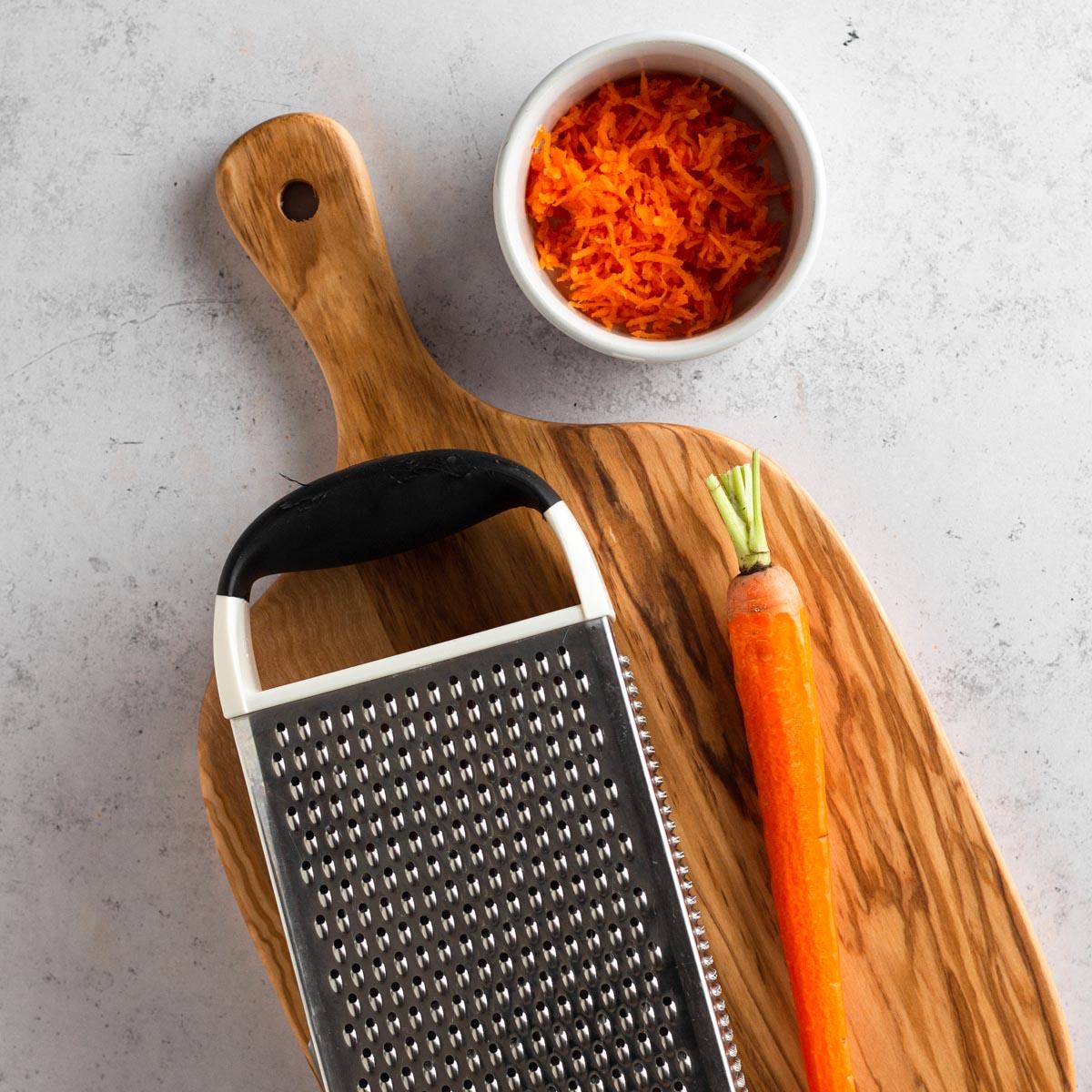 Close-up shot of grating carrots for carrot cake