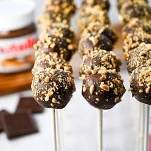 close up of a perfectly dipped chocolate hazelnut rocher cake pop