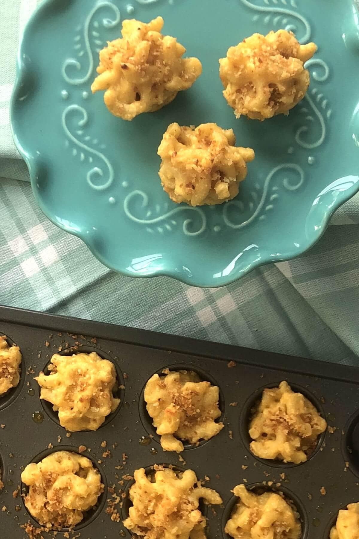 Close-up shot of golden brown mac and cheese fritters on a plate