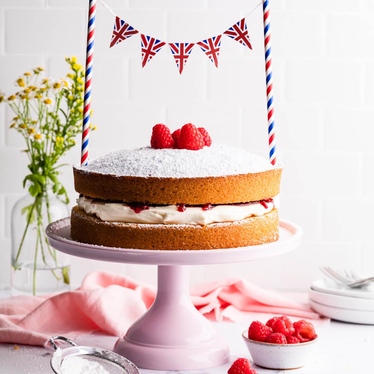 A beautifully decorated sponge cake on a cake stand