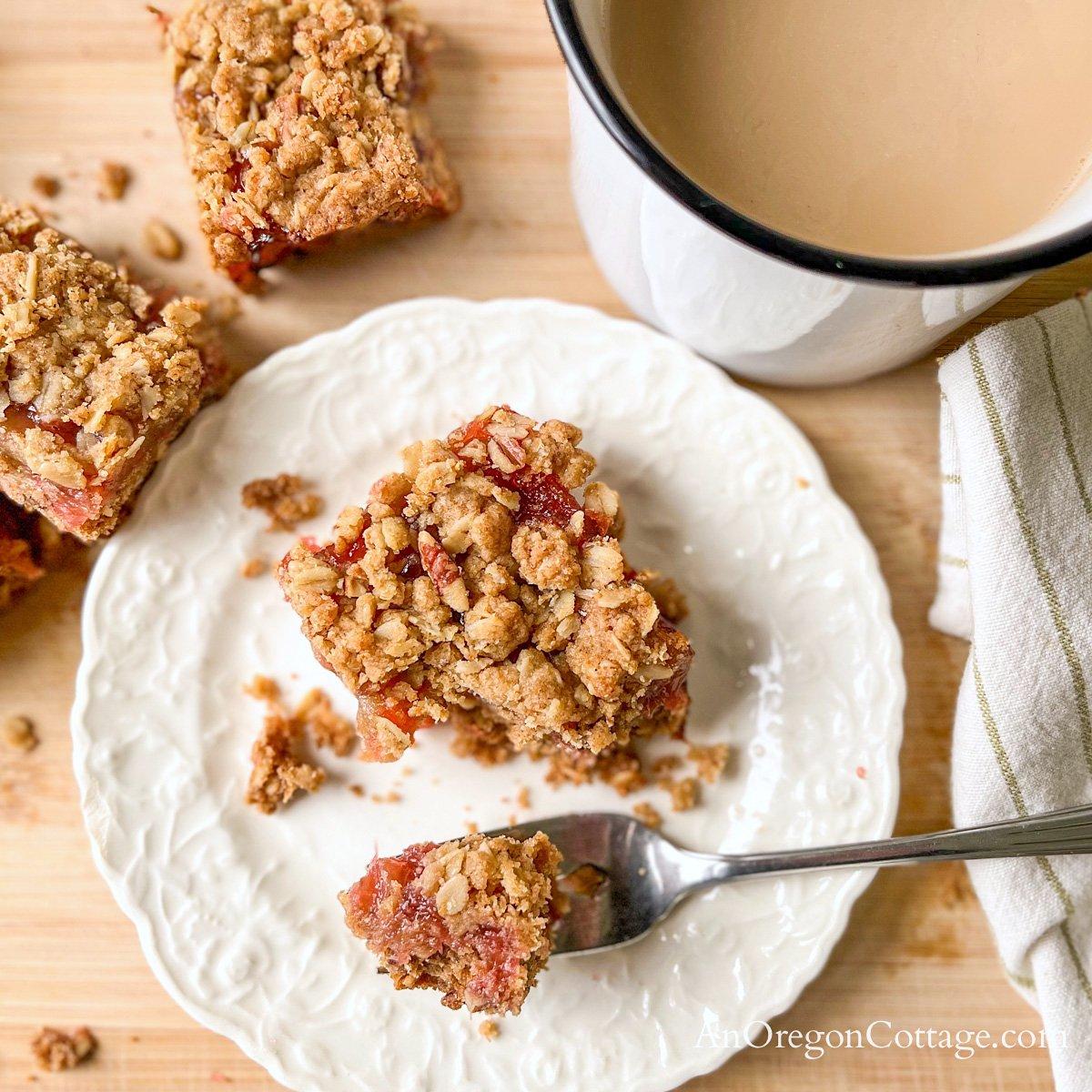 Honey Rhubarb Bars with Walnut Topping being served on a plate