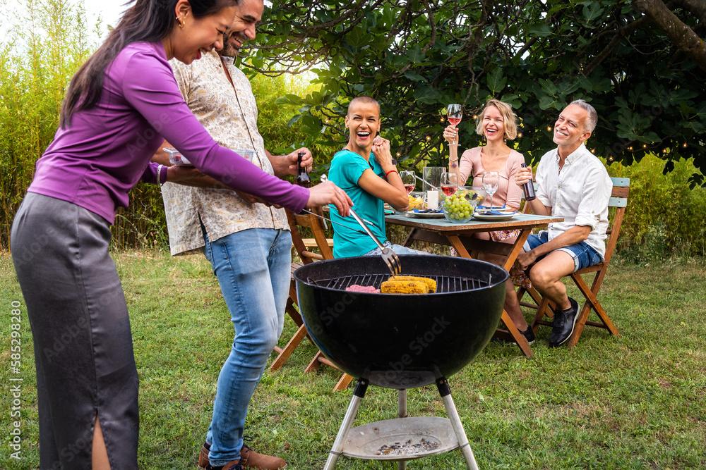 family enjoying grilled loach at an outdoor dinner