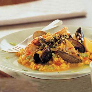 Mussel and Saffron Risotto plated with fresh herbs