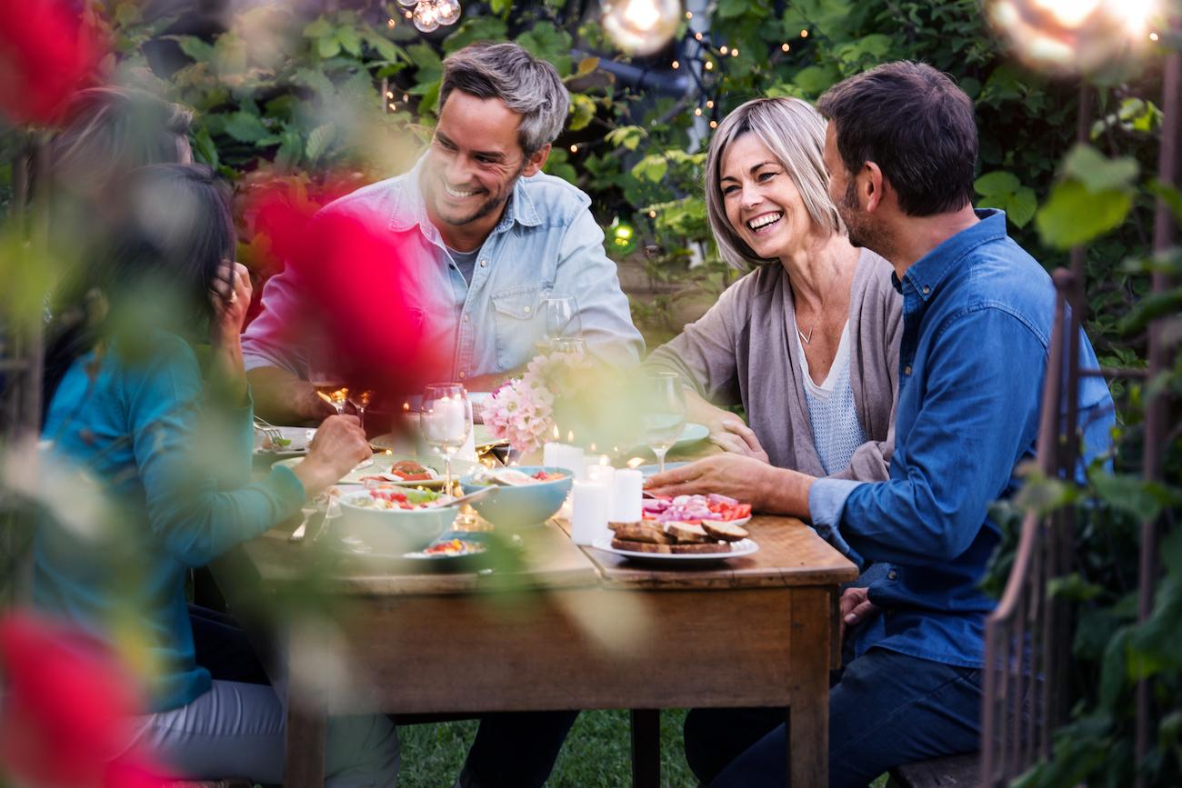 friends enjoying rhubarb mint lemonade at an outdoor garden party