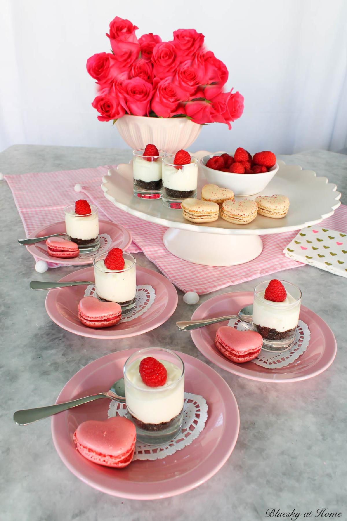Overhead shot of a beautifully decorated Valentine's Raspberry Rose Cheesecake on a white cake stand