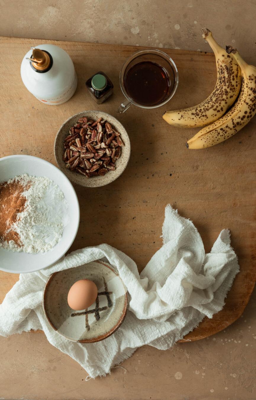 ingredients for banana nut muffins on a wooden surface