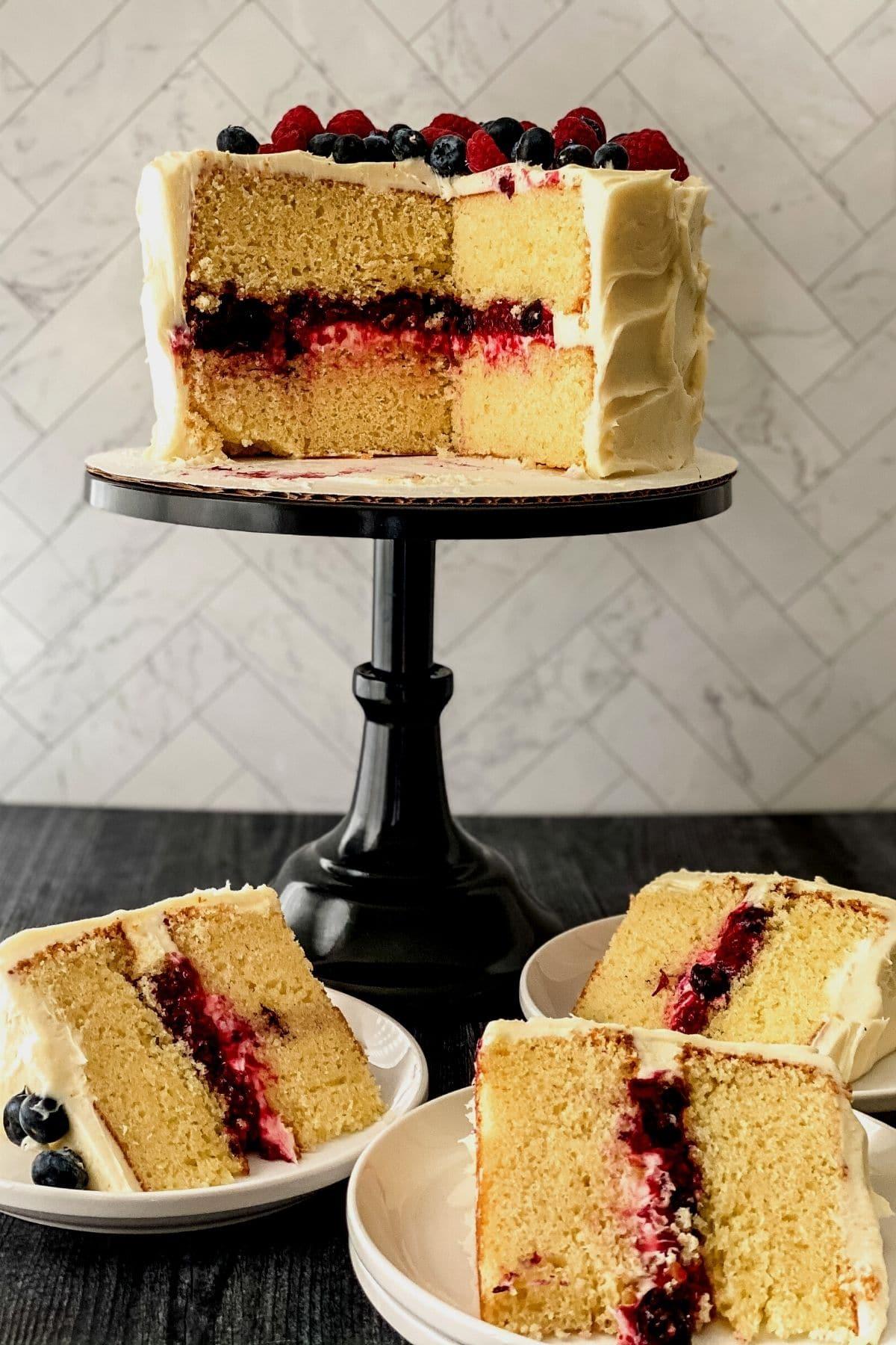 vanilla birthday cake with goji berry compote on a cake stand