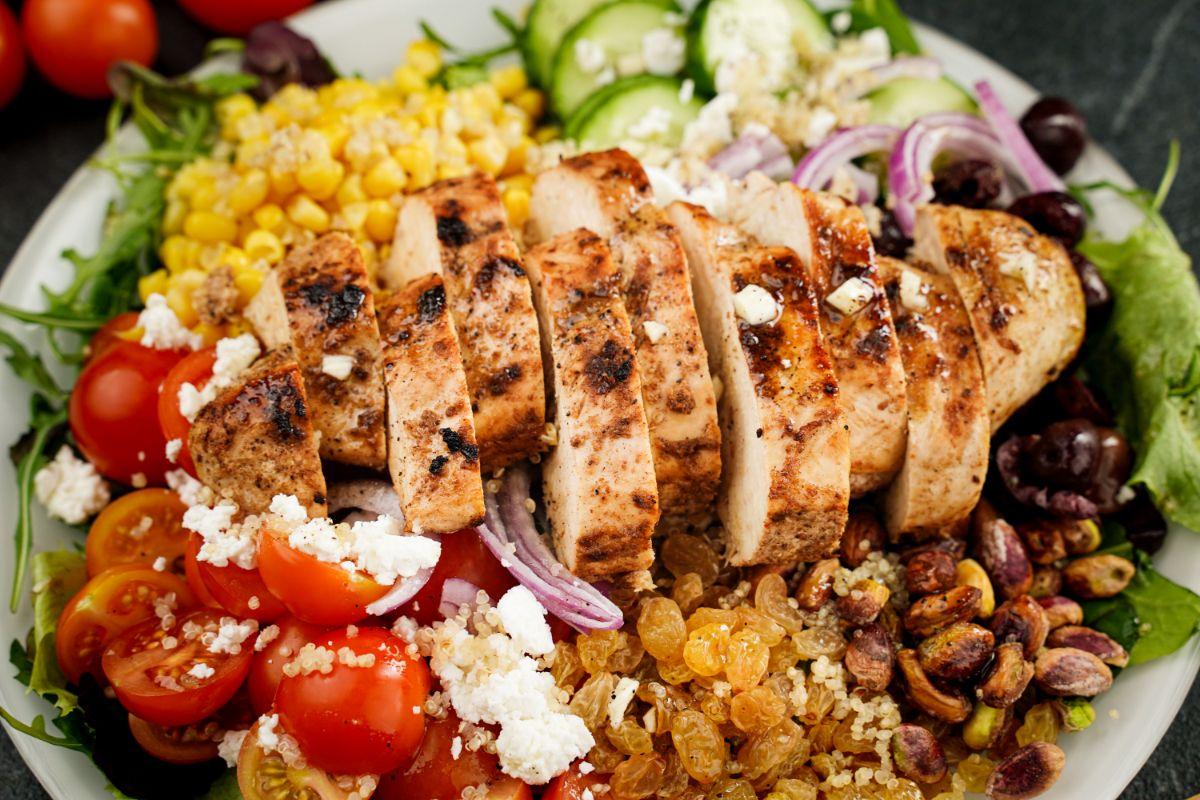 Close-up of grilled chicken in a Greek quinoa bowl