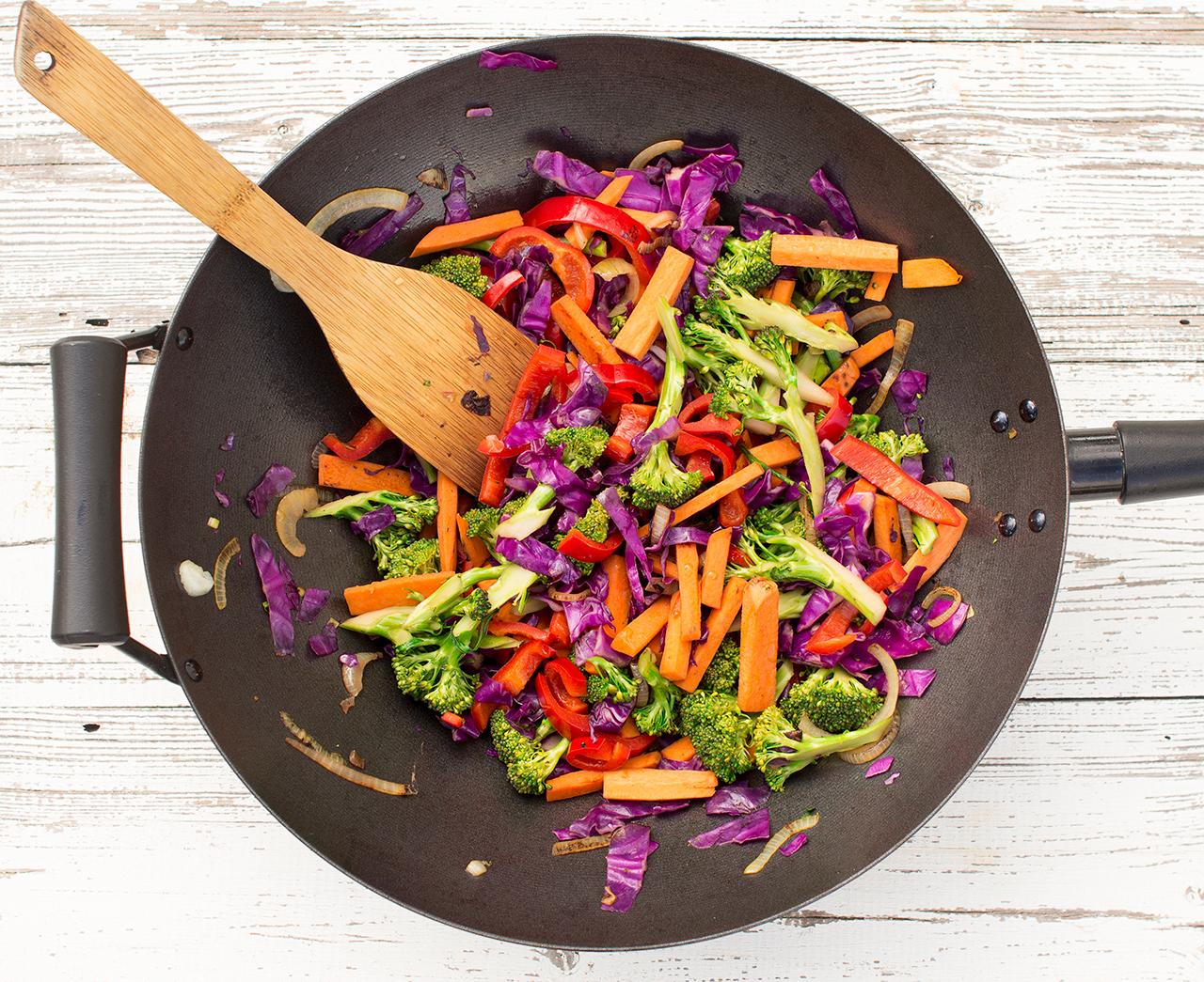 a vibrant stir-fry with peaches, colorful vegetables, and a glossy hoisin sauce, served in a wok