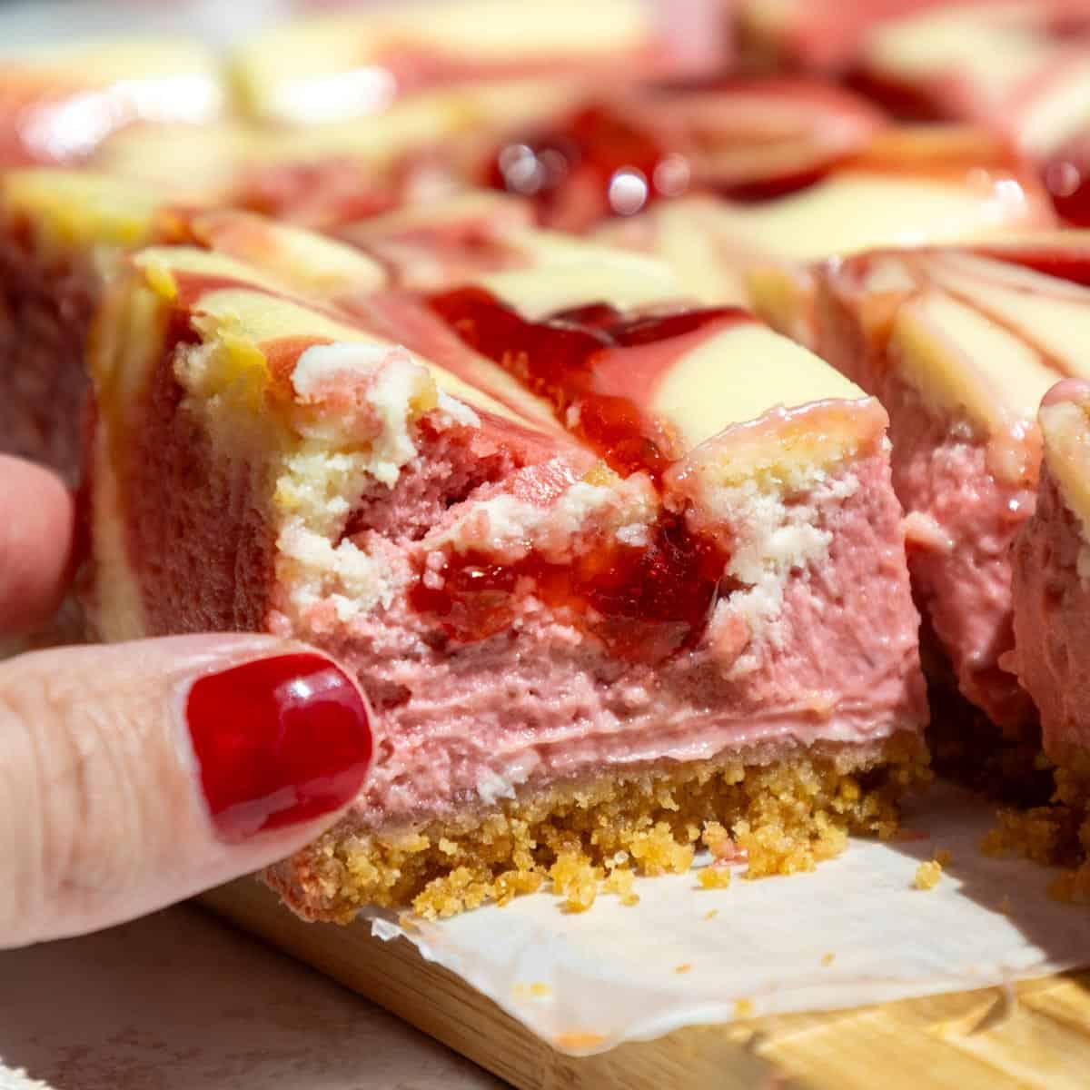 Close-up shot of a slice of Marbled Strawberry Cheesecake Bar