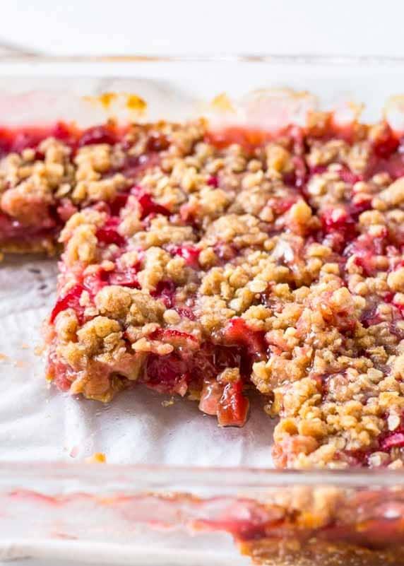 a group of people enjoying slices of rhubarb crumble together at a table
