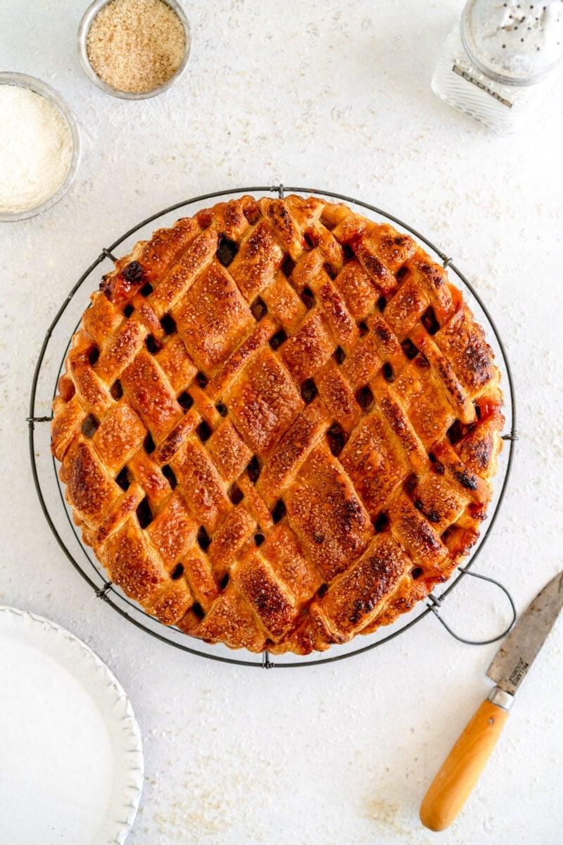 overhead shot of a freshly baked grape rhubarb pie, cut into slices