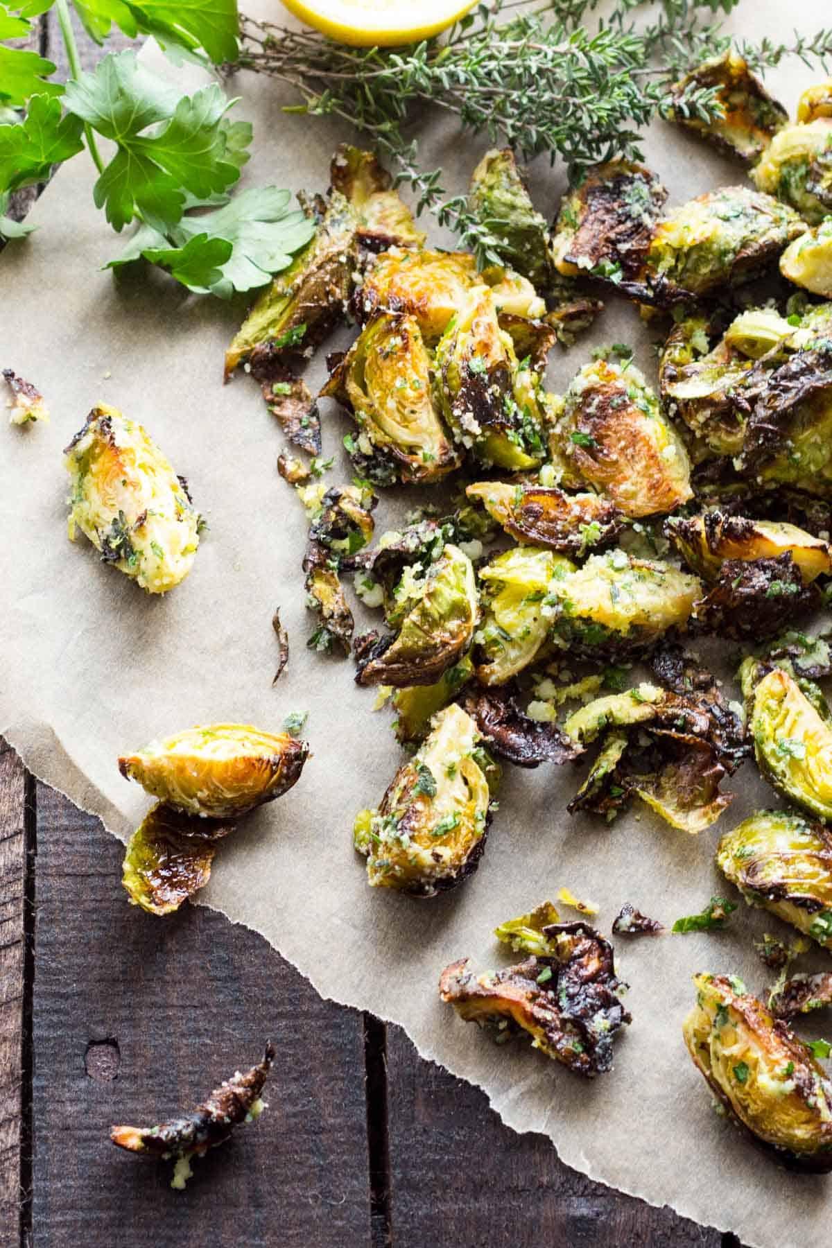 lemon-herb roasted brussels sprouts with pine nuts on a baking sheet