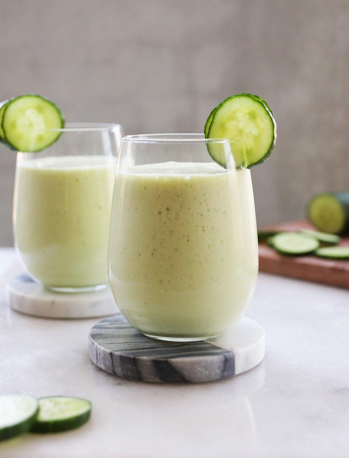 side view of cucumber and coconut smoothie being poured into a glass