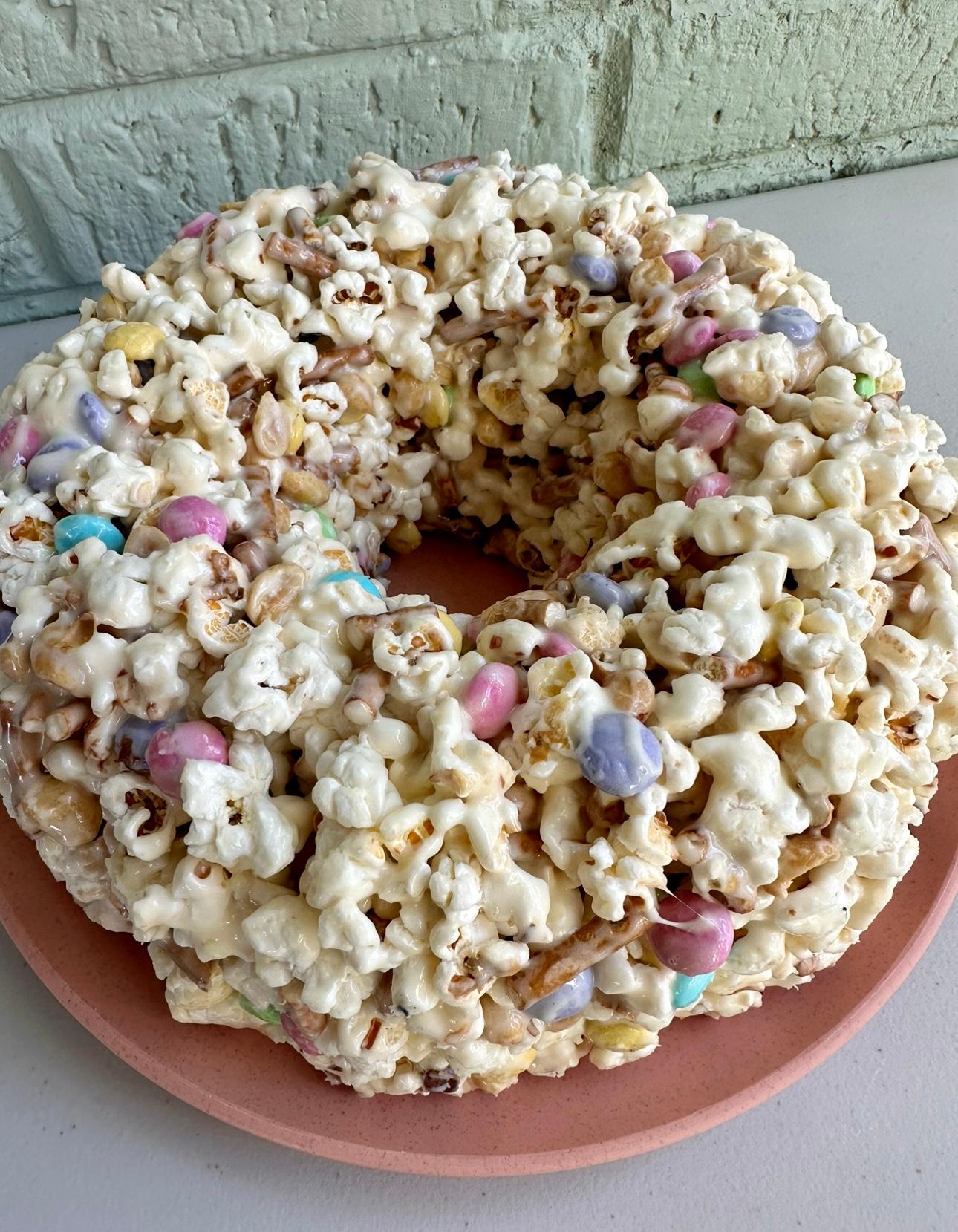 slice of vanilla cake with visible popcorn crunch