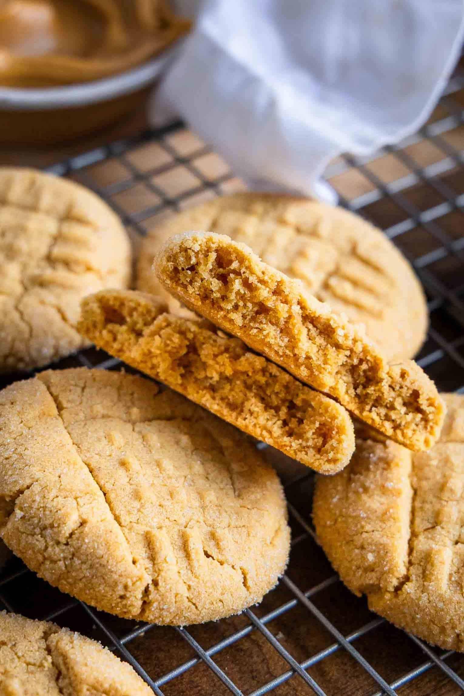 close-up of peanut butter cookie with crackly edges and soft interior, on a cooling rack, golden brown, inviting
