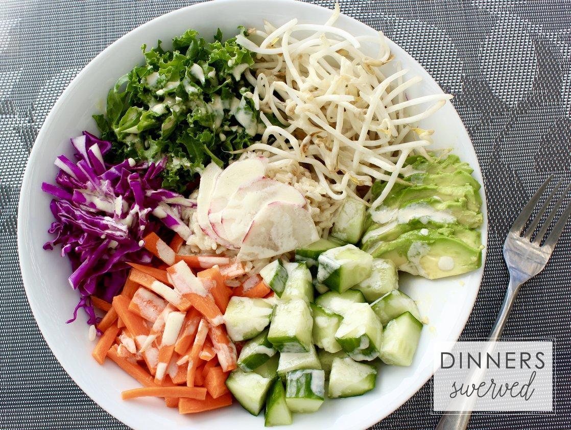 close-up of the wasabi ginger dressing being drizzled over the bowl