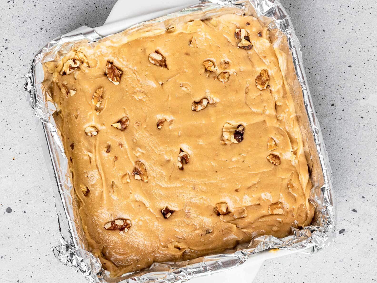 overhead view of a baking pan filled with sugar-free maple walnut fudge before being cut