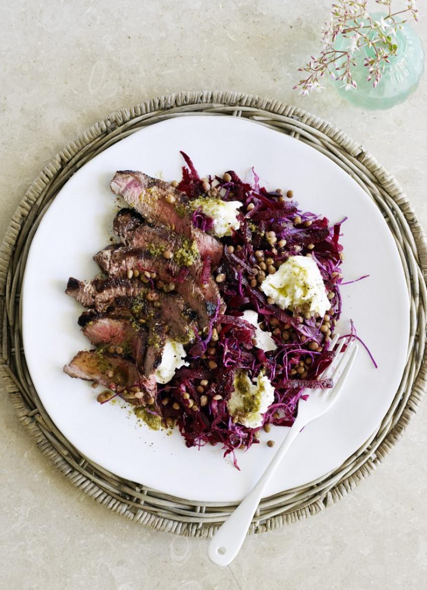 close-up of steak and red cabbage salad in a bowl
