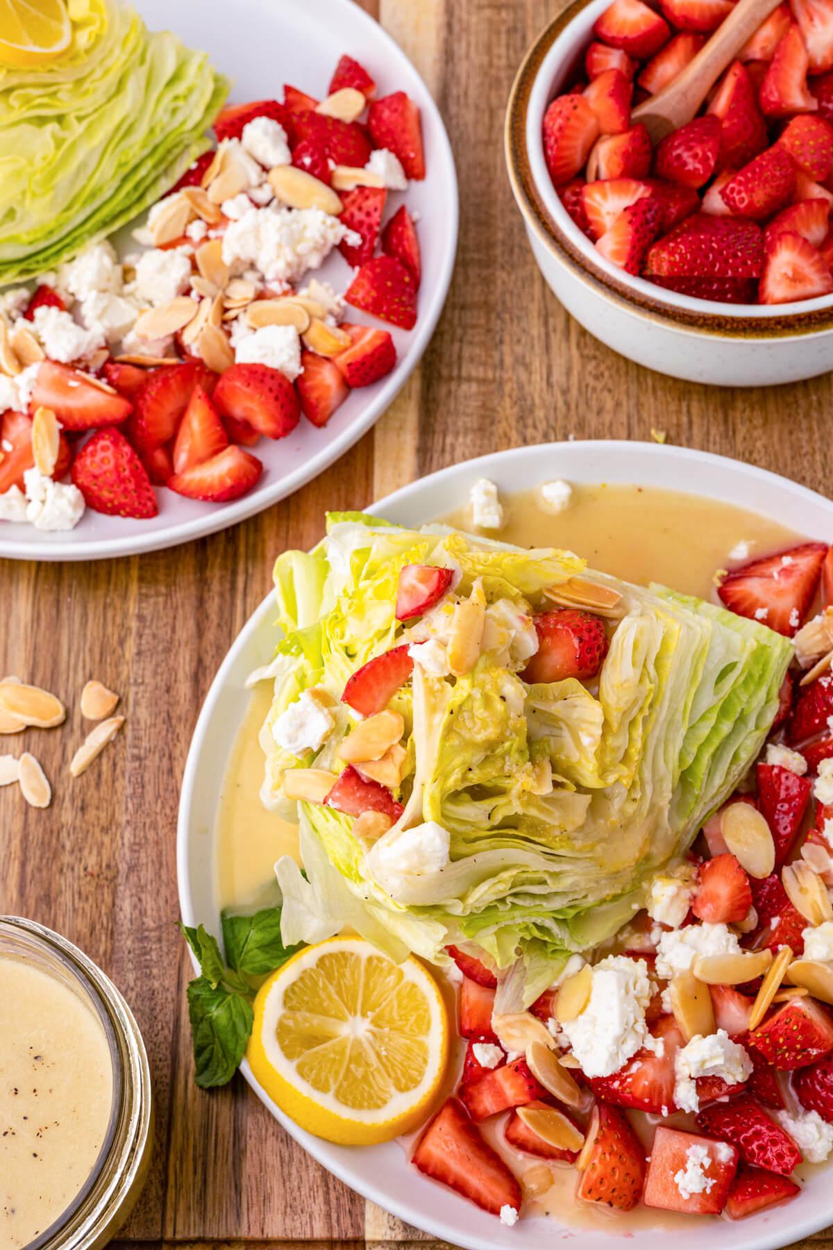 A close-up shot of a fork lifting a portion of the salad, showcasing the strawberries, feta, and lettuce.