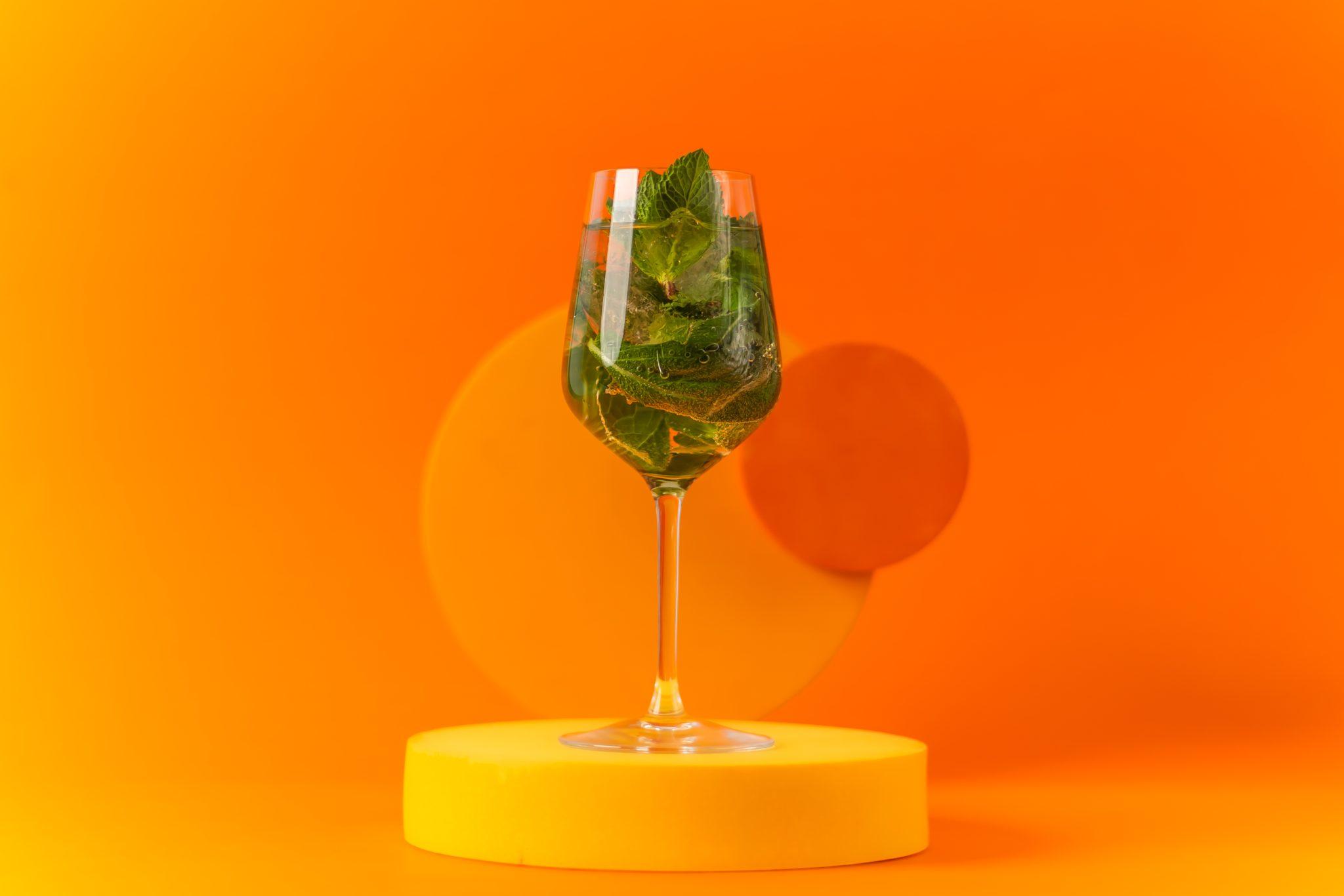 Hugo Spritz in a wine glass with orange slice garnish