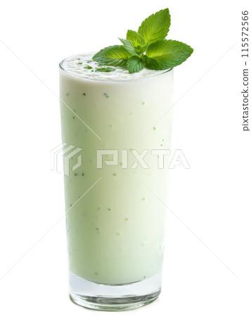 a close-up shot of the mint majesty lassi being poured into a glass, with condensation on the glass