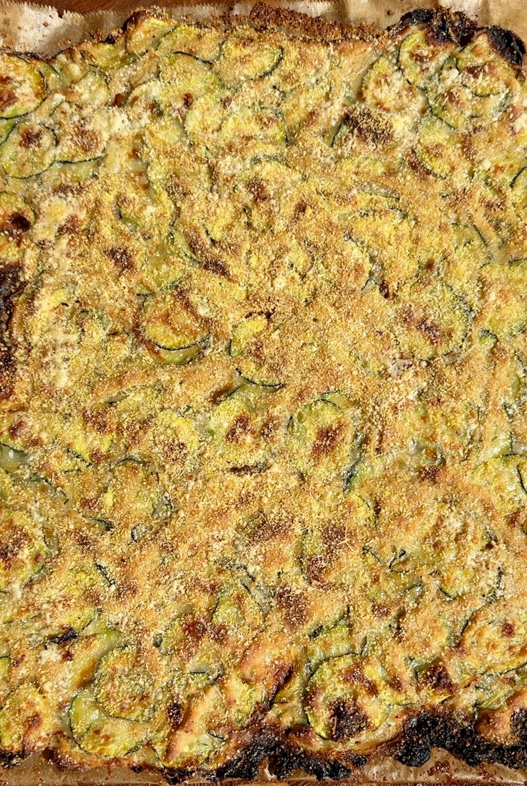 Overhead view of a freshly baked zucchini crumble in a rustic dish