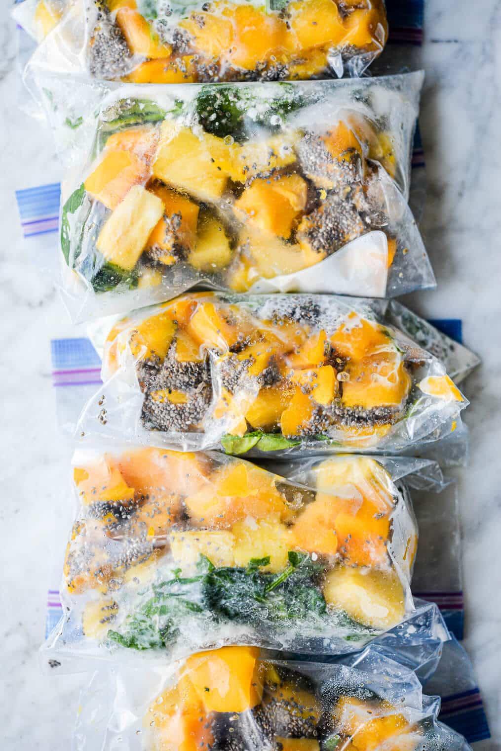 close-up of assembled smoothie bags filled with tropical fruits and spinach