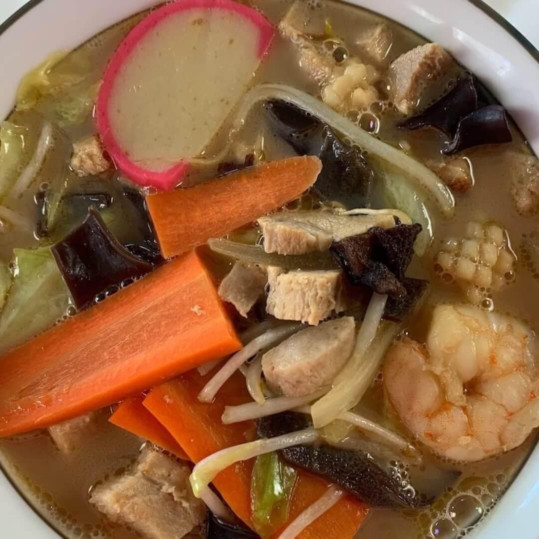 Close-up of the various ingredients in Nagasaki Champon: shrimp, squid, cabbage, carrots, and kamaboko.