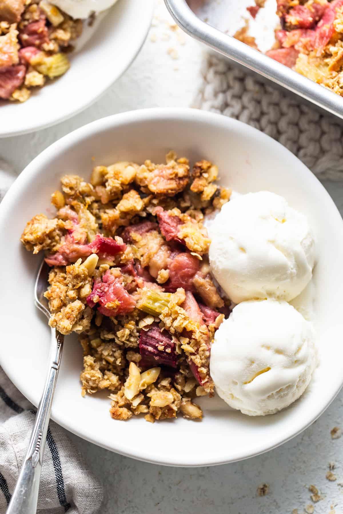 honey rhubarb oatmeal crisp served with vanilla ice cream