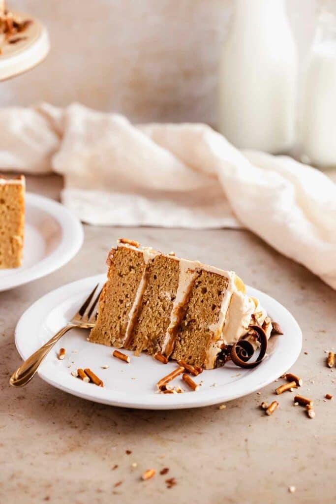slice of butterscotch rhubarb butter cake with butterscotch sauce dripping down