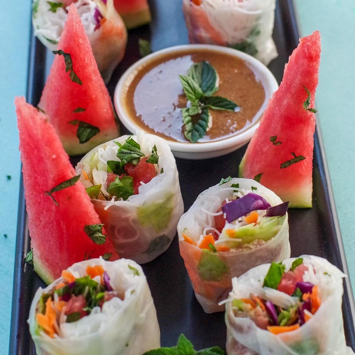melon spring rolls with prosciutto and mint