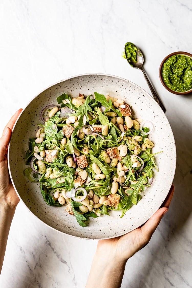 white bean arugula salad in a bowl