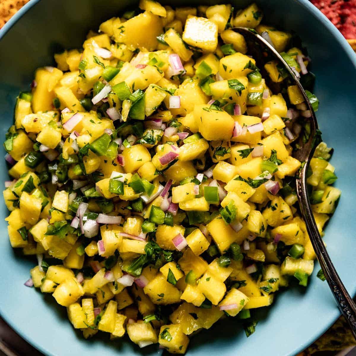 chef preparing fresh pineapple and mango salsa
