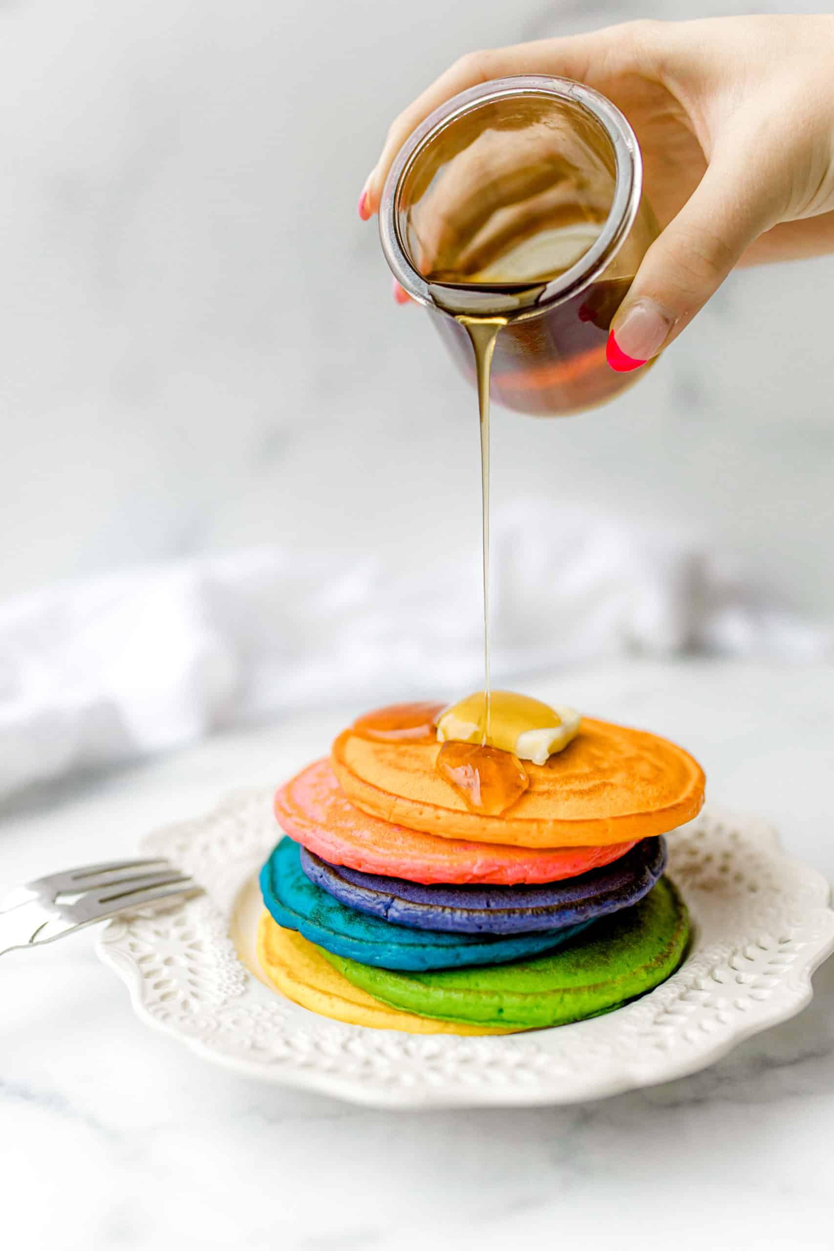 close up shot of pancake batter being poured onto a hot griddle
