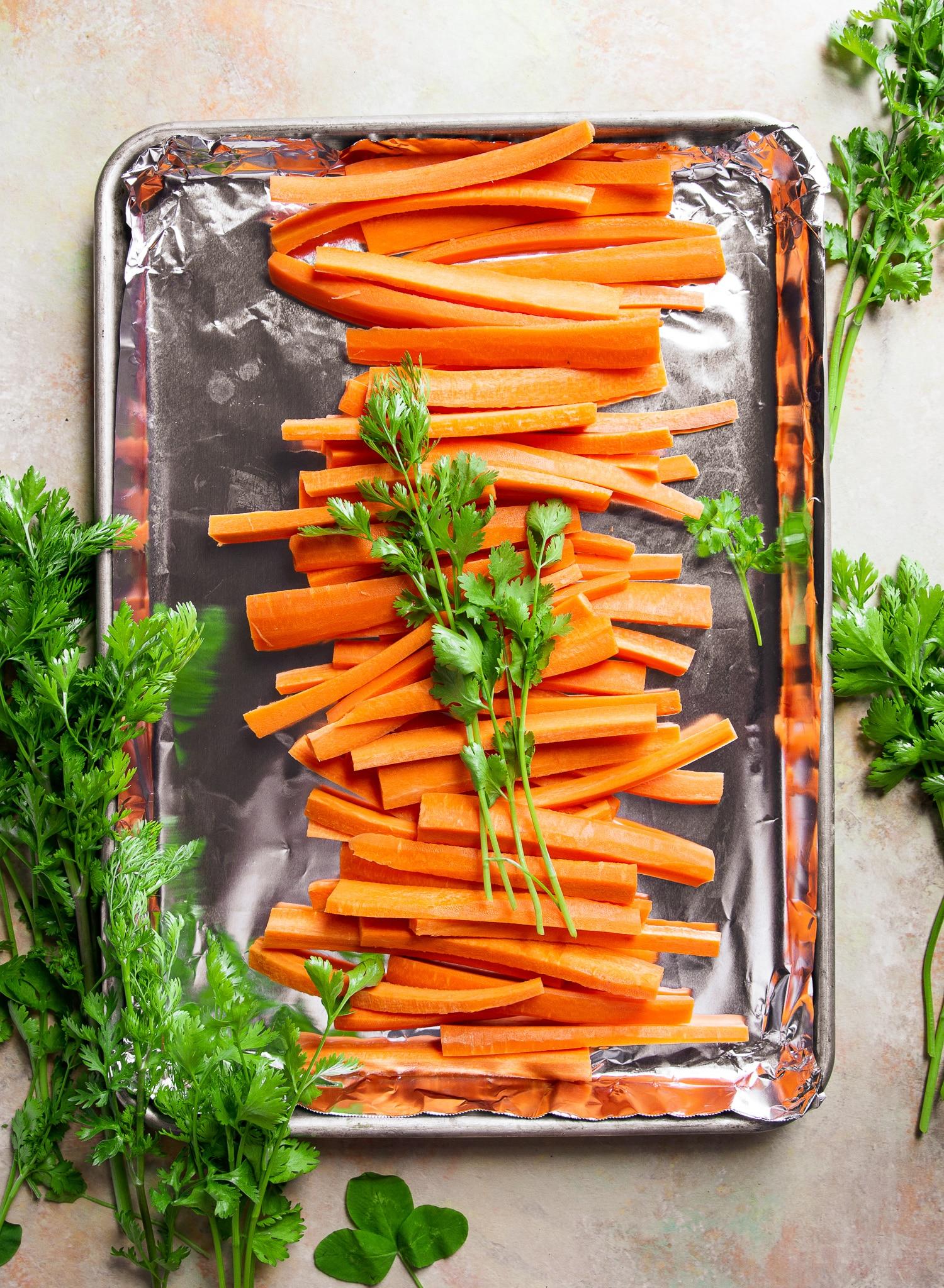 overhead shot of ginger sesame carrot fries on a baking sheet
