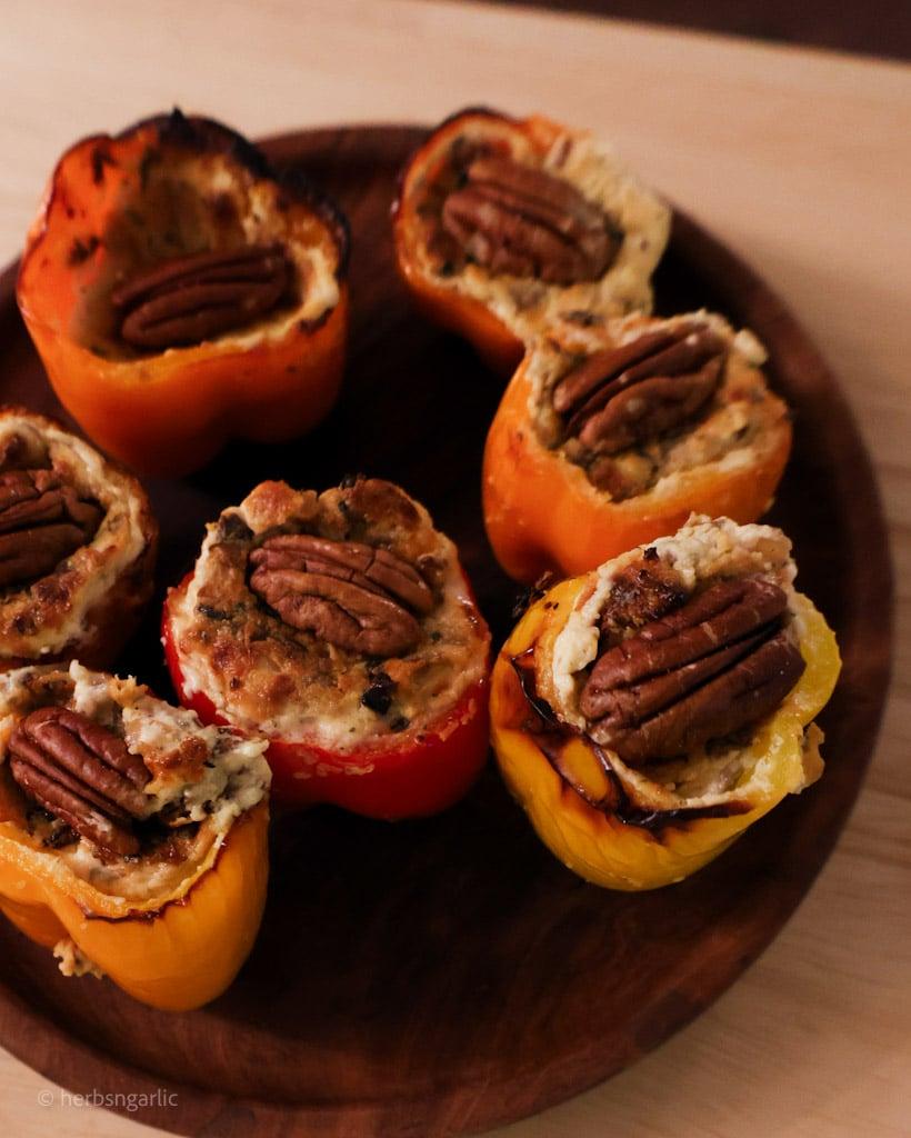 Mushroom Wellington stuffed bell peppers on a rustic wooden board