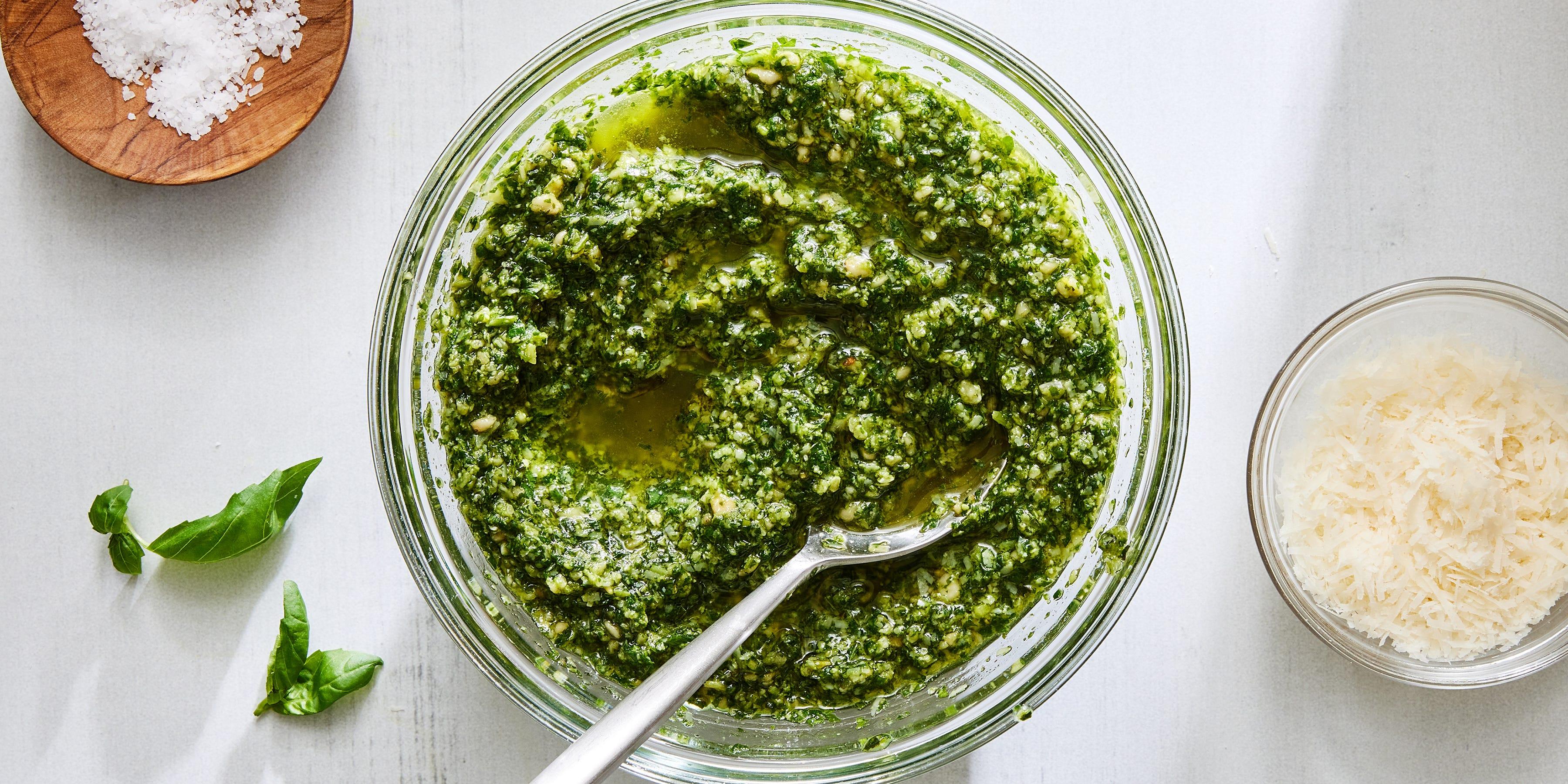 basil pesto being stirred into a bowl of cake batter