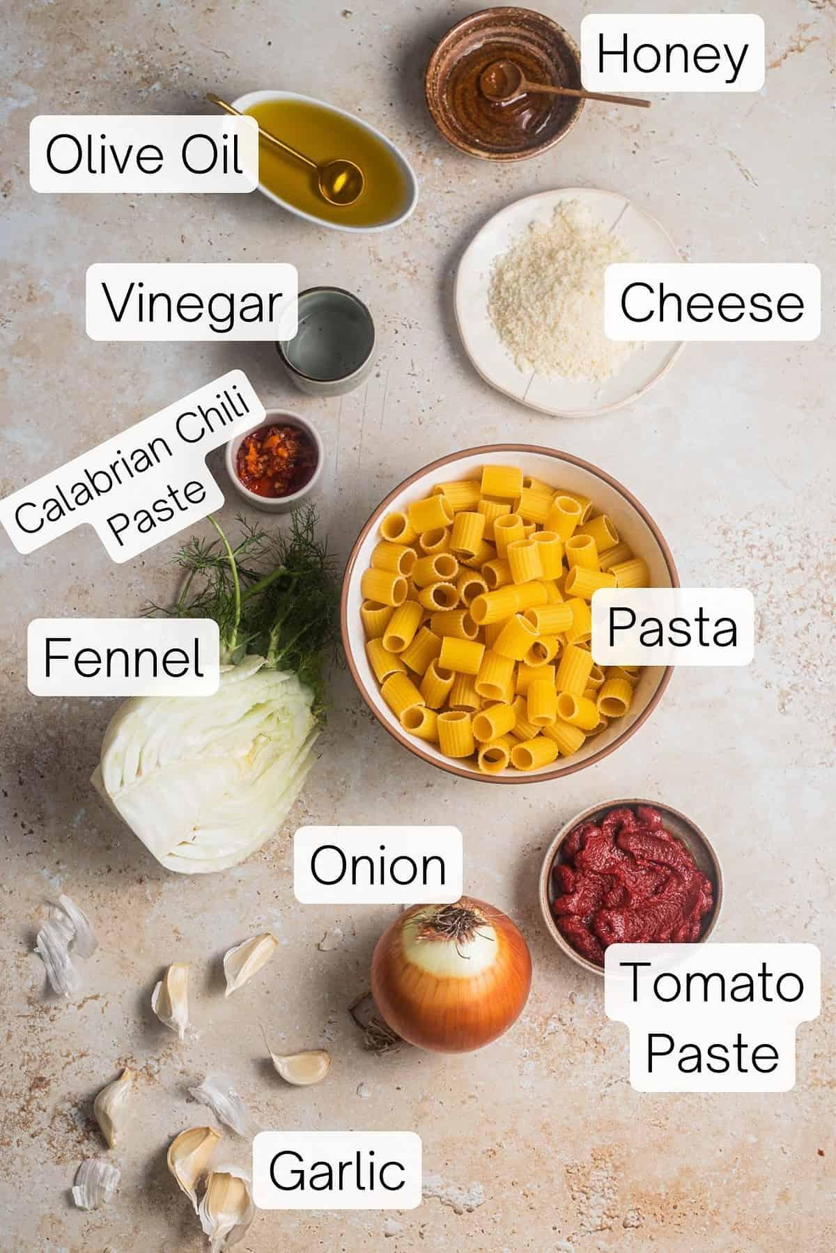 Overhead shot of ingredients for Spicy Calabrian chili oil pasta arranged on a wooden table