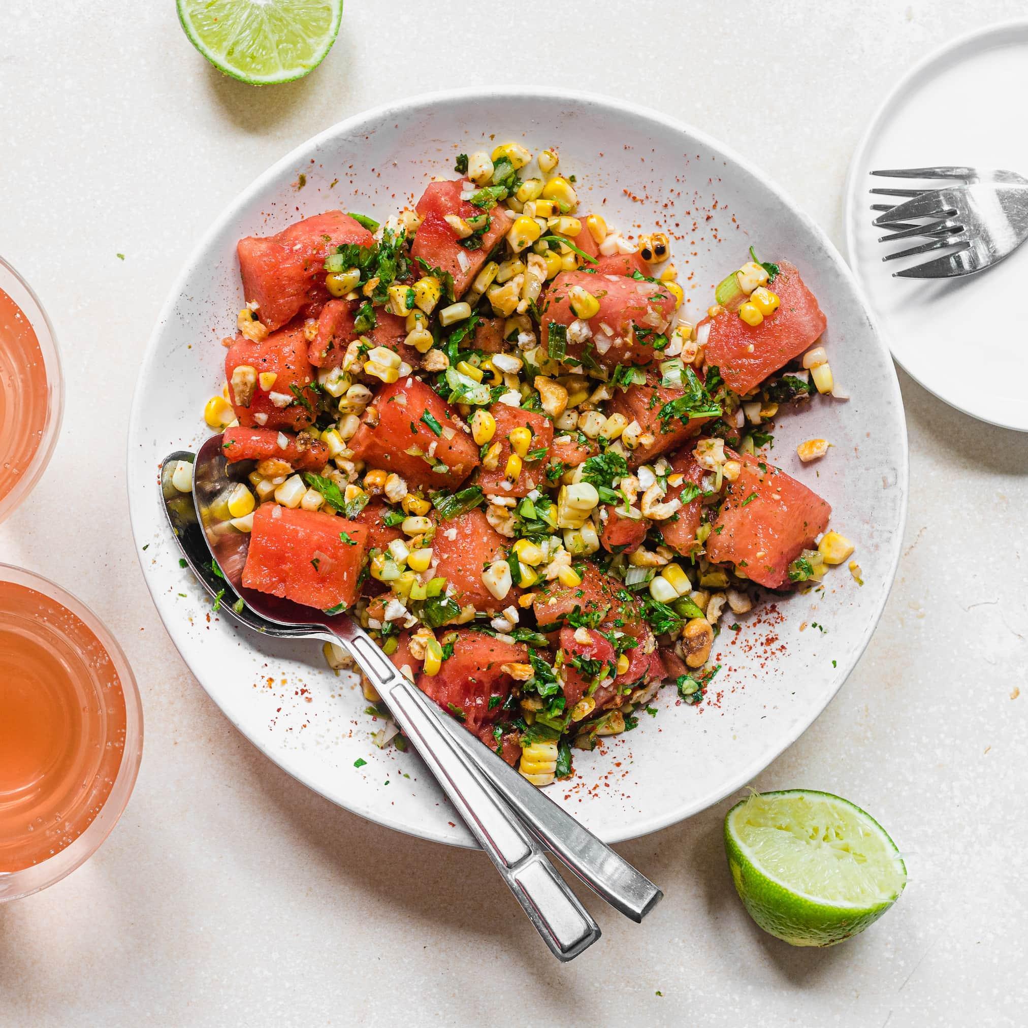 grilled corn and watermelon salad with fresh mint and lime wedges