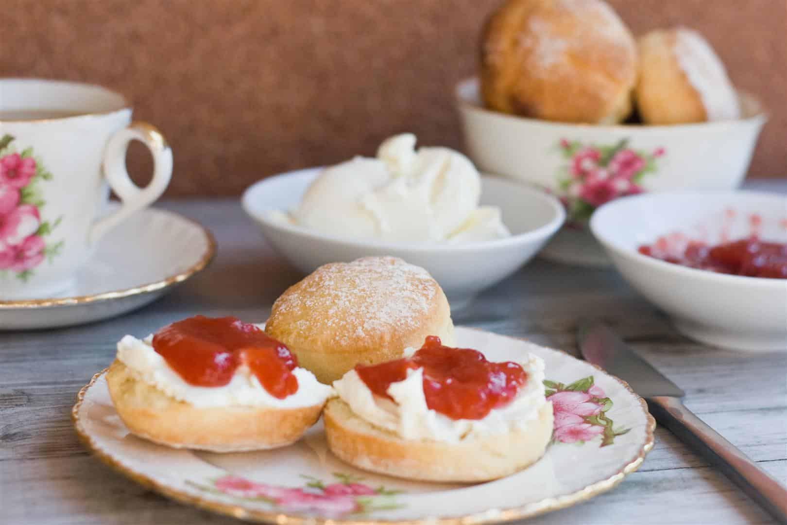 pink salt and tarragon scones served on a plate with a cup of tea