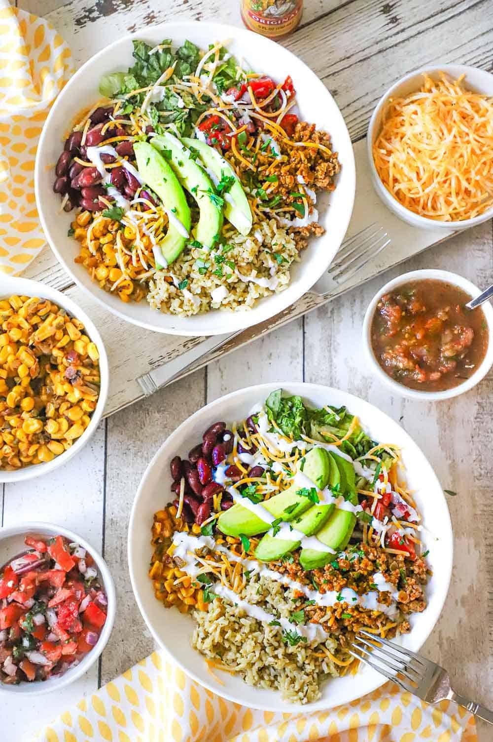 overhead shot of a colorful turkey and black bean bowl with various toppings