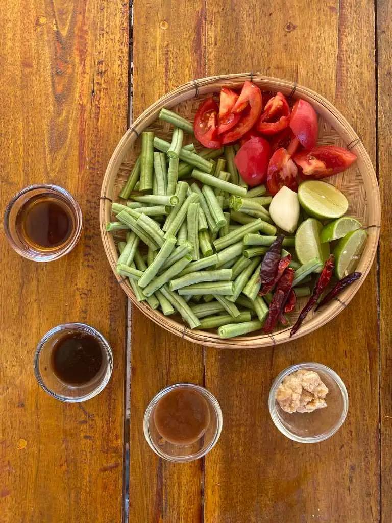 Ingredients for Thai bean salad arranged on a wooden table