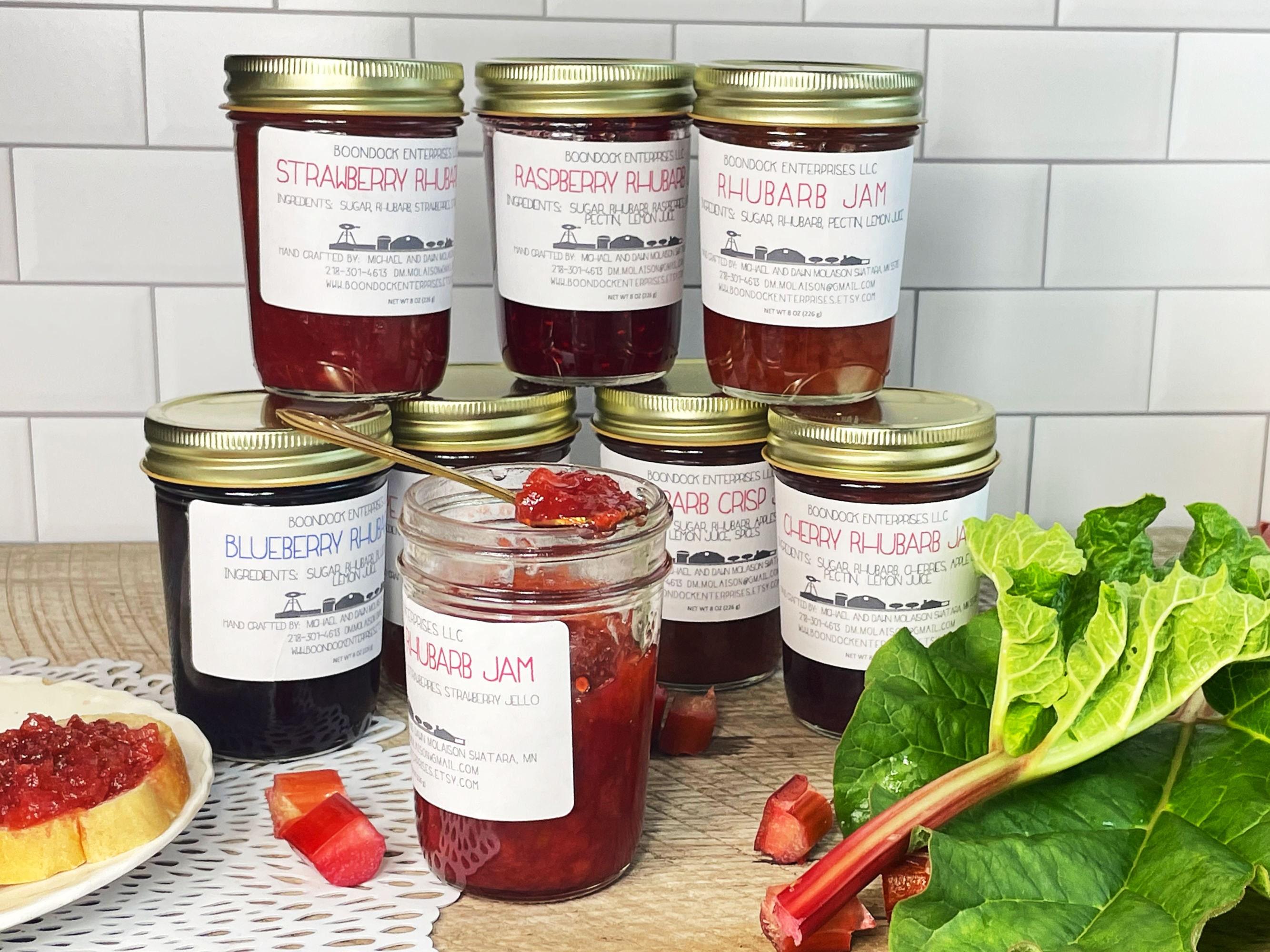 jars of homemade pumpkin spice rhubarb jam on a wooden table