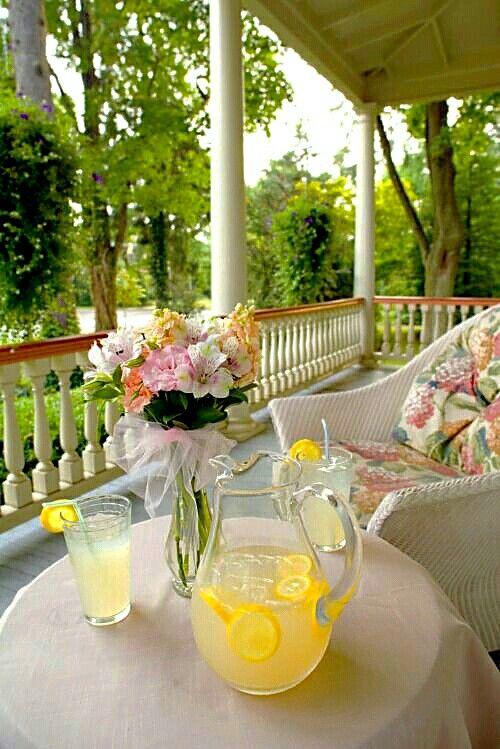 pitcher of rosemary lemonade on a porch with summer vibe