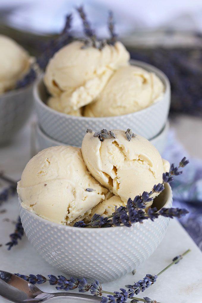 scoops of vanilla lavender ice cream in a bowl with fresh lavender sprigs