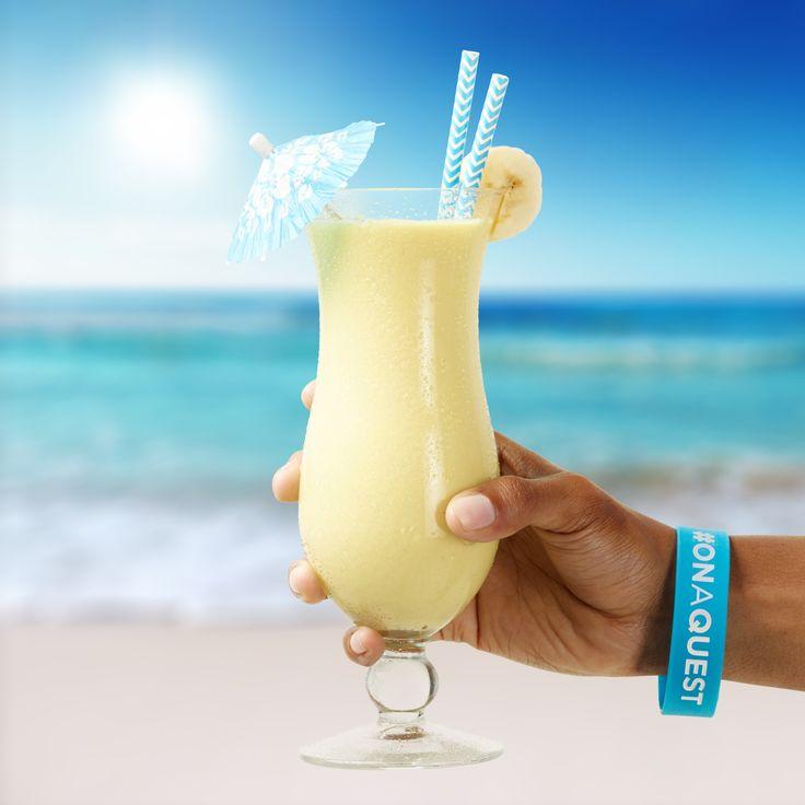 person enjoying a pina colada protein smoothie on a tropical beach