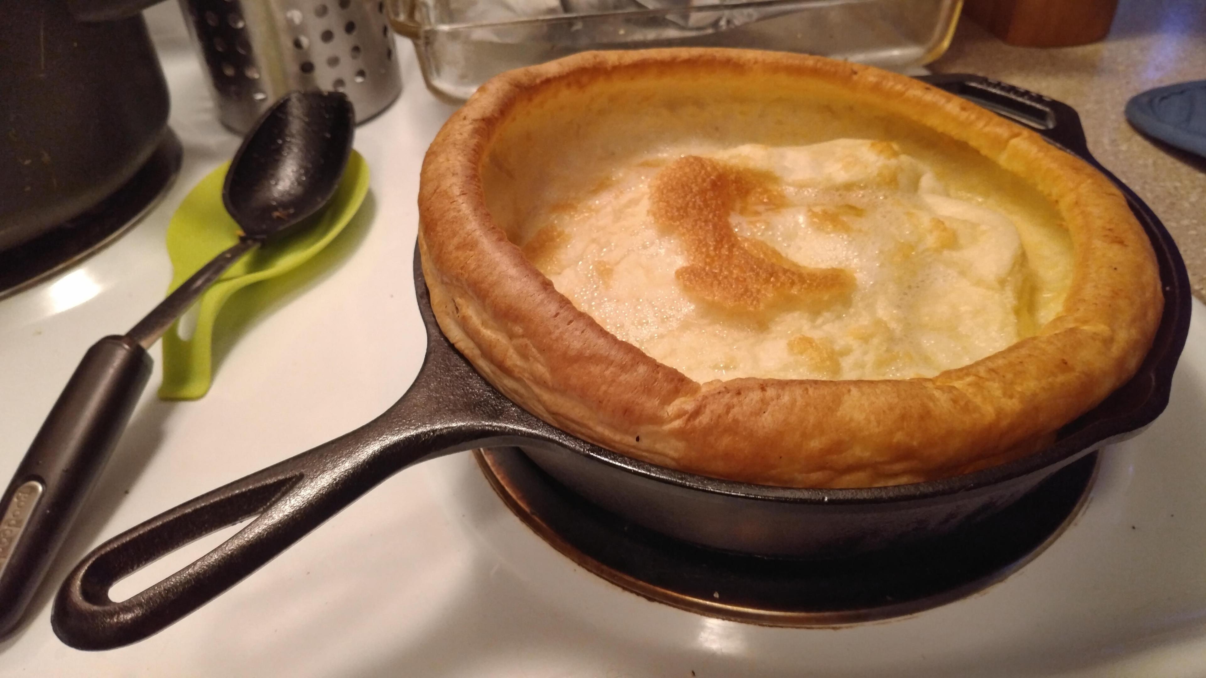 close up of golden Yorkshire puddings in a cast iron pan